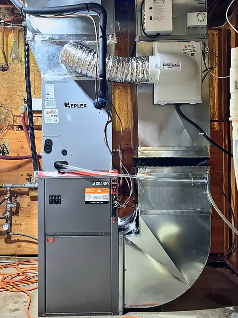 Humidifier mounted on the supply plenum above a furnace