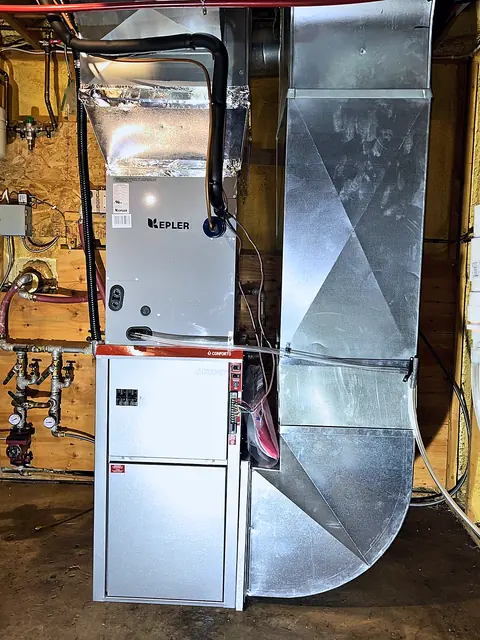 Furnace with a heat pump coil cabinet on top and new sheet-metal ductwork