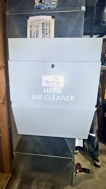 Whole-home HEPA air cleaner cabinet beside a furnace