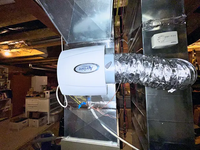 Whole-home humidifier on a furnace plenum with a flexible bypass duct, water line and drain tube