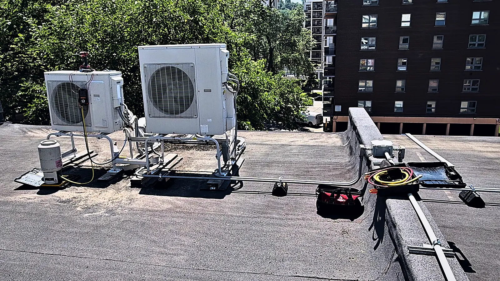 Two ductless outdoor units on a flat roof