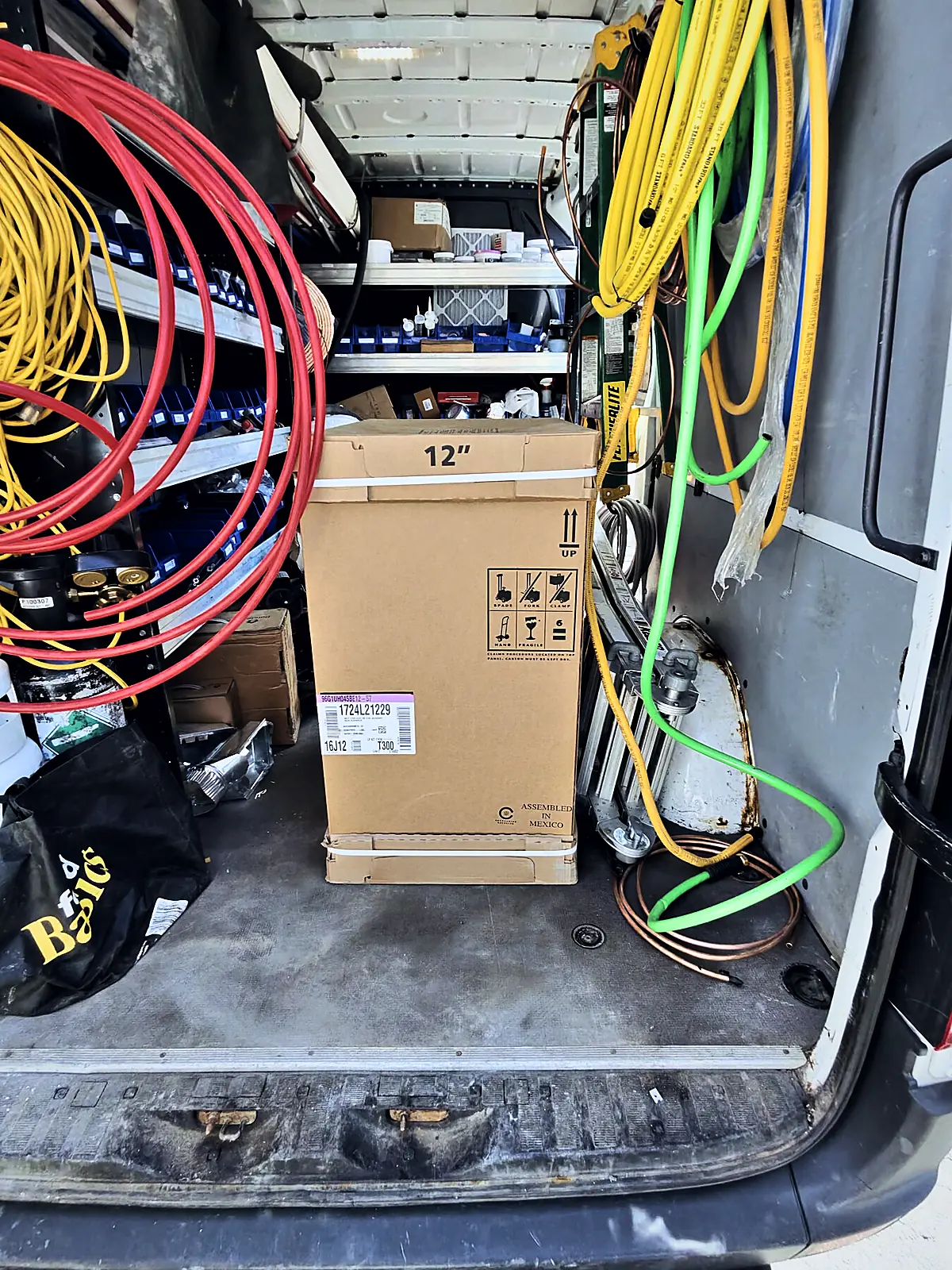 Service van with reels of wire, tools and parts on board
